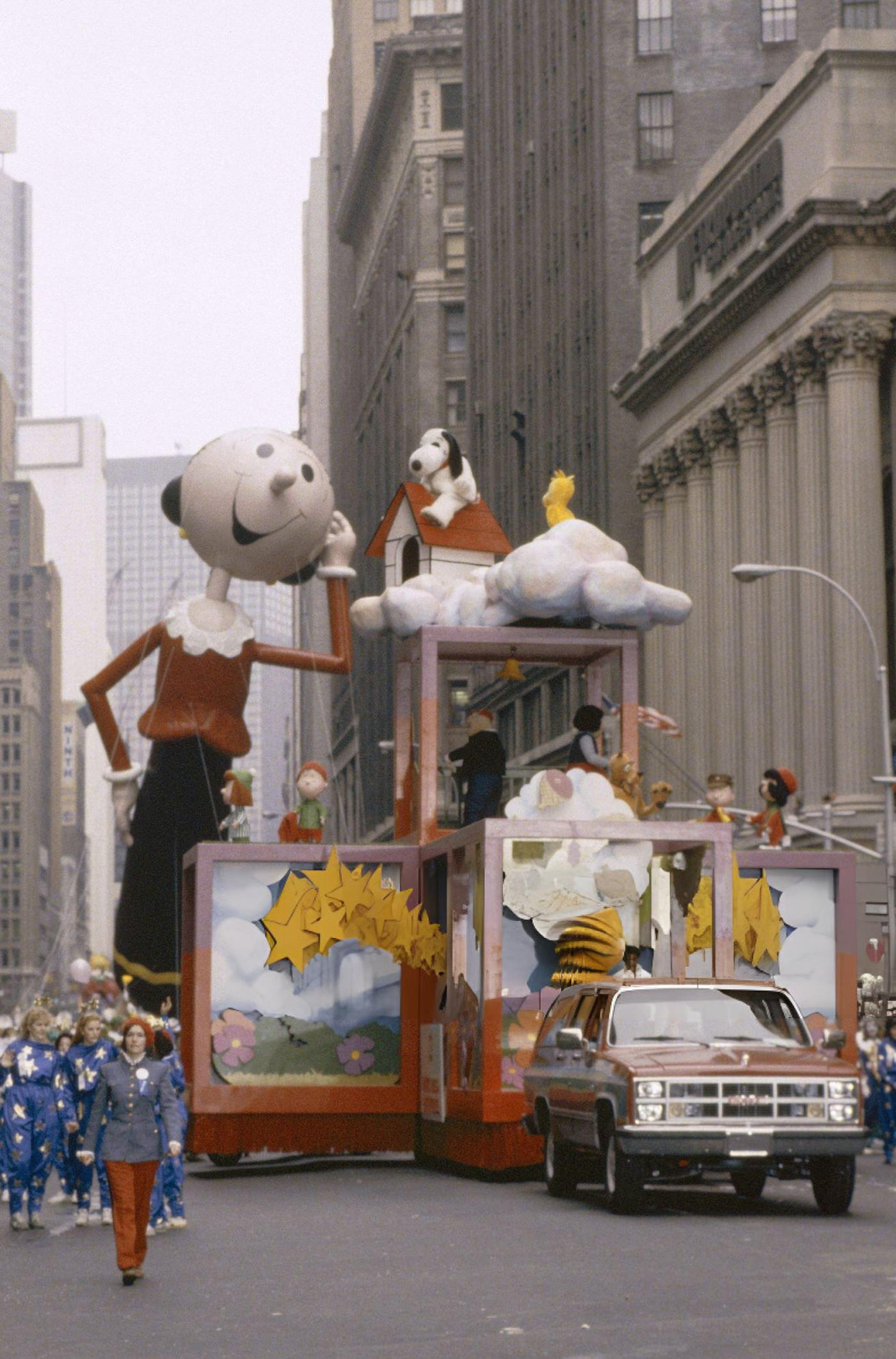 Garfield, Snoopy, And Charlie Brown Ride A Float In Front Of The Olive Oyl Balloon During The 1983 Macy'S Thanksgiving Day Parade.