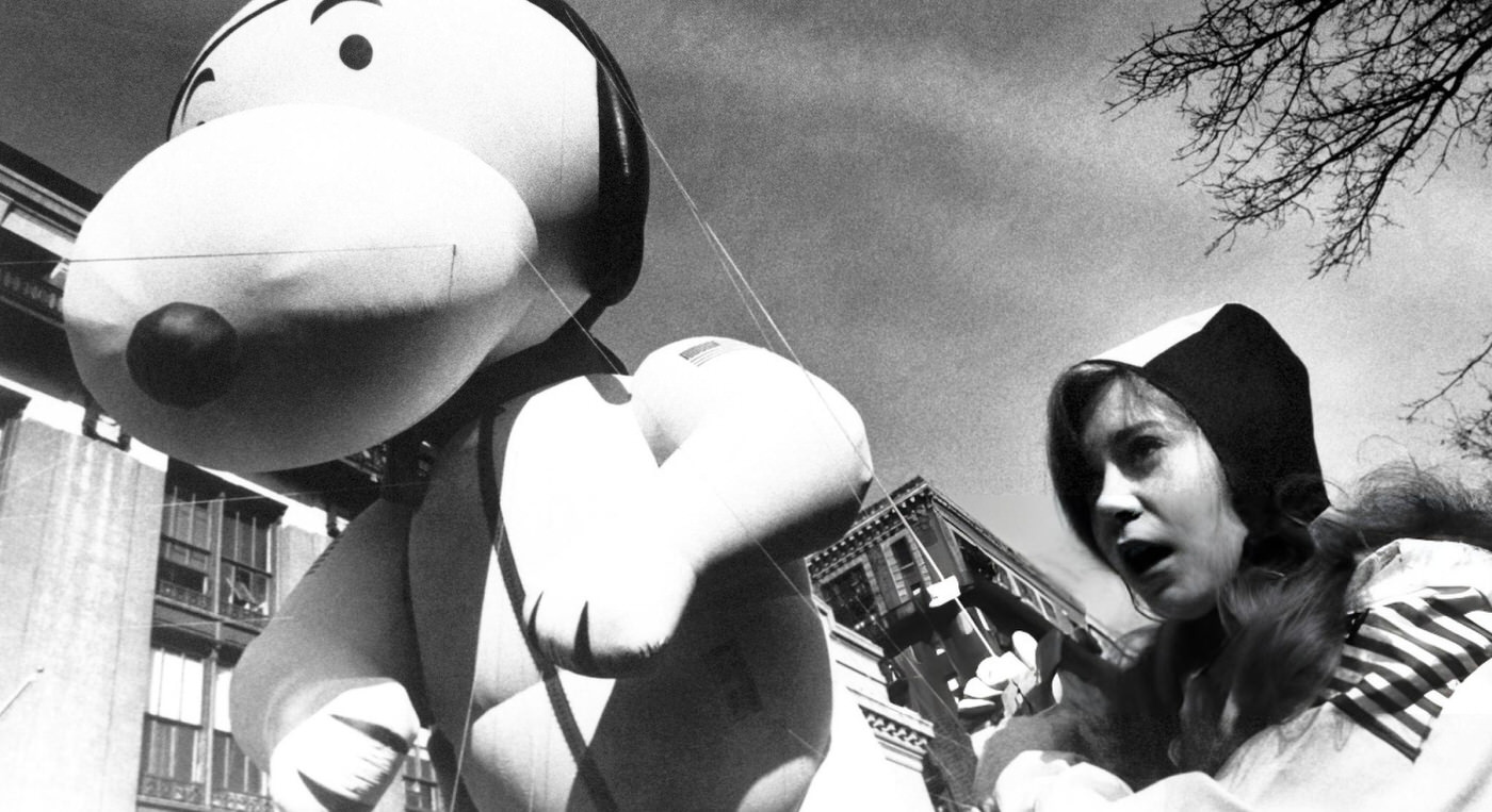 The Peanuts Character 'Snoopy The Aviator' As A Young Girl Dressed Like Snoopy Walks Along The Parade Route During The 55Th Annual Macy'S Thanksgiving Day Parade, November 26, 1981.