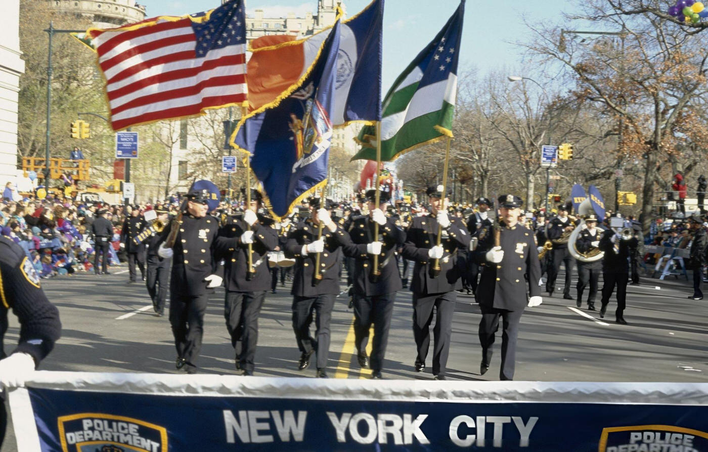 The New York City Police Department Colorguard And Band March During The 1997 Macy'S Thanksgiving Day Parade.