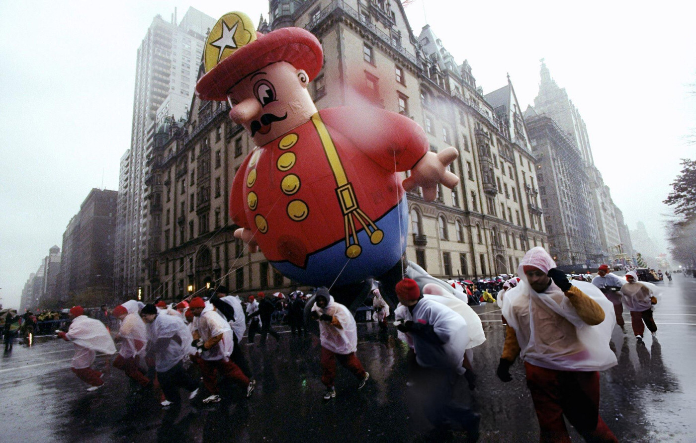 Balloon Handlers Fight The Wind During The 72Nd Annual Macy'S Thanksgiving Day Parade.