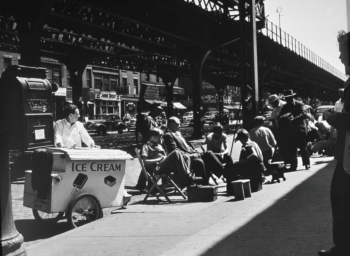 A Group Of Shoeshine Boys Take A Break On A Sunny Day Near An Elevated Train Track, New York, Late 1940S.