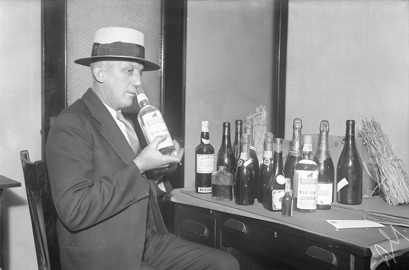 Inspector Sniffing Liquors Alleged To Have Been Seized In Raid On Room 1030 Of 200 Fifth Avenue.