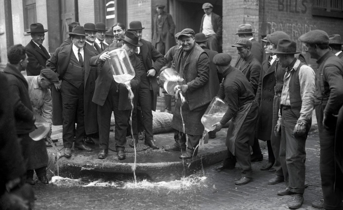 New York City Liquor Agent Izzy Einstein Dumping Liquor Into Gutter During Prohibition.