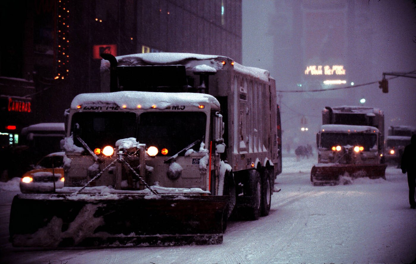 Sanitation Trucks Equipped With Snow Plows Travel Through Times Square At Night During Winter Snowstorm, 2001.