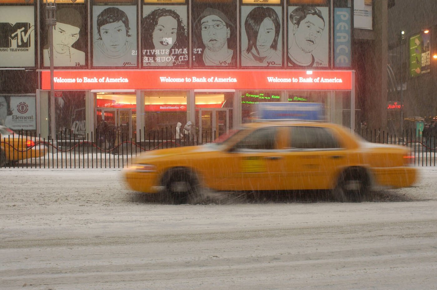 A Taxi Speeds By A Bank Of America Branch In Times Square During A Winter Snowstorm, 2005.