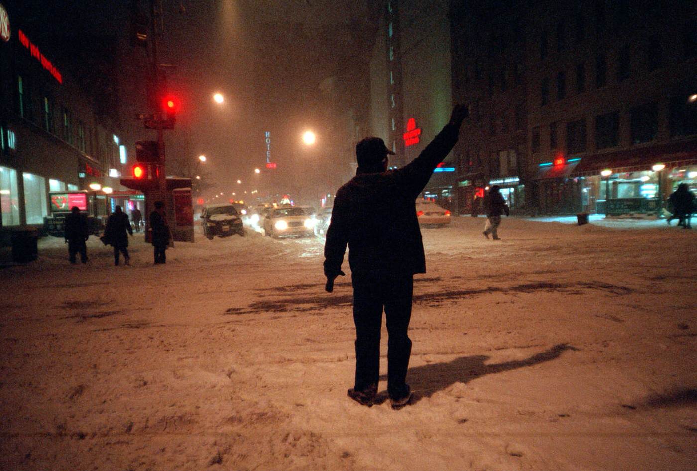 A Traveler Searches For An Empty Cab In Chelsea, 2005.