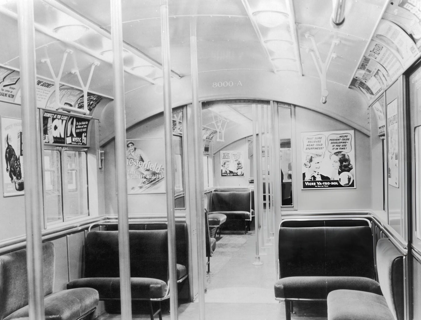Interior View Of A Subway Car With Upholstered Seats And Advertising Posters, New York City, Circa 1935.