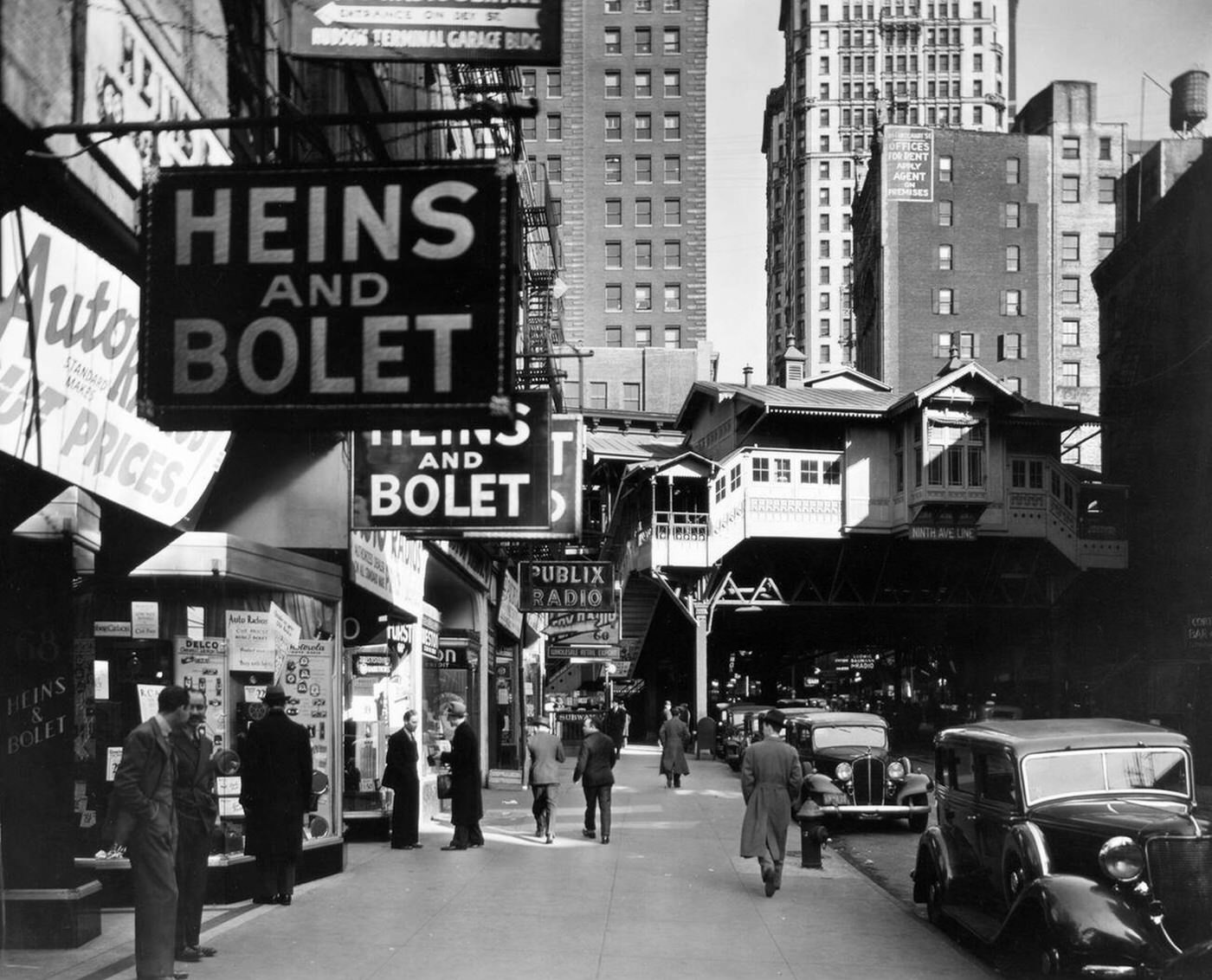 Men Window Shop At A Store Selling Radios On Cortlandt Street, With The Ninth Avenue Elevated Railroad Station And A Subway Entrance Visible, Circa 1936.