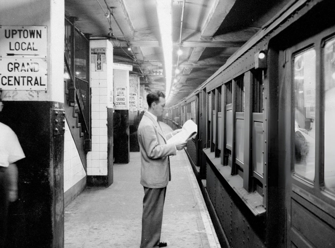 A Subway Passenger Reads His Paper Under New Fluorescent Lighting At The Grand Central Station Subway Terminal, 1950S