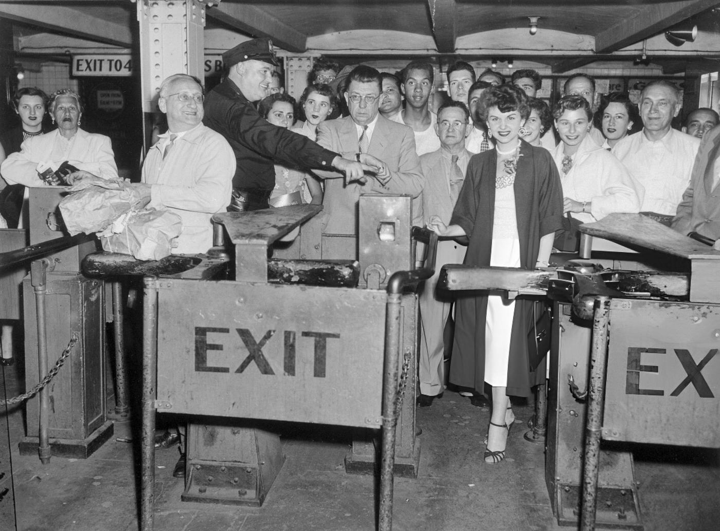 Samuel Begley Deposits The Last Dime To Go Through A Turnstile As Judy Reed Prepares To Insert A Token, Marking The Start Of The 15-Cent Fare.