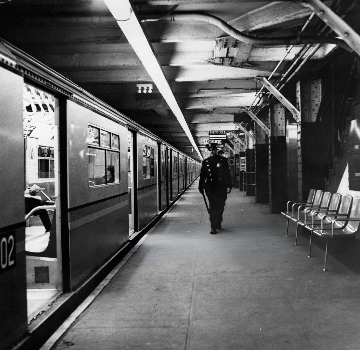 A Policeman Patrols An Empty New York Subway Station.