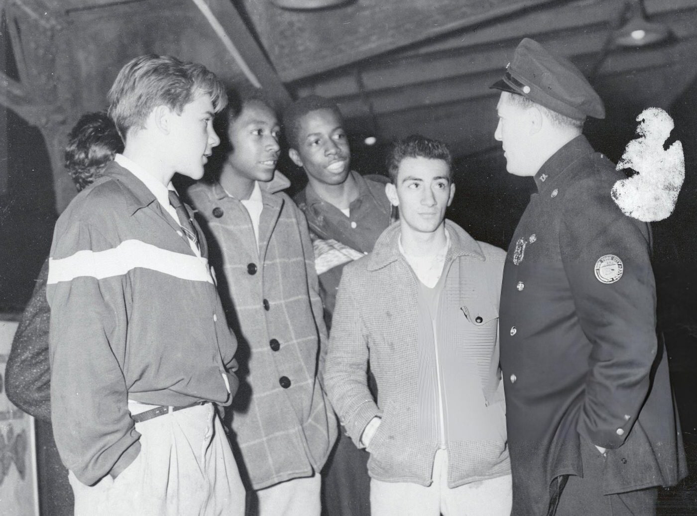A Transit Policeman Questions A Group Of Teenagers In The Corridors Of A New York Subway Station.