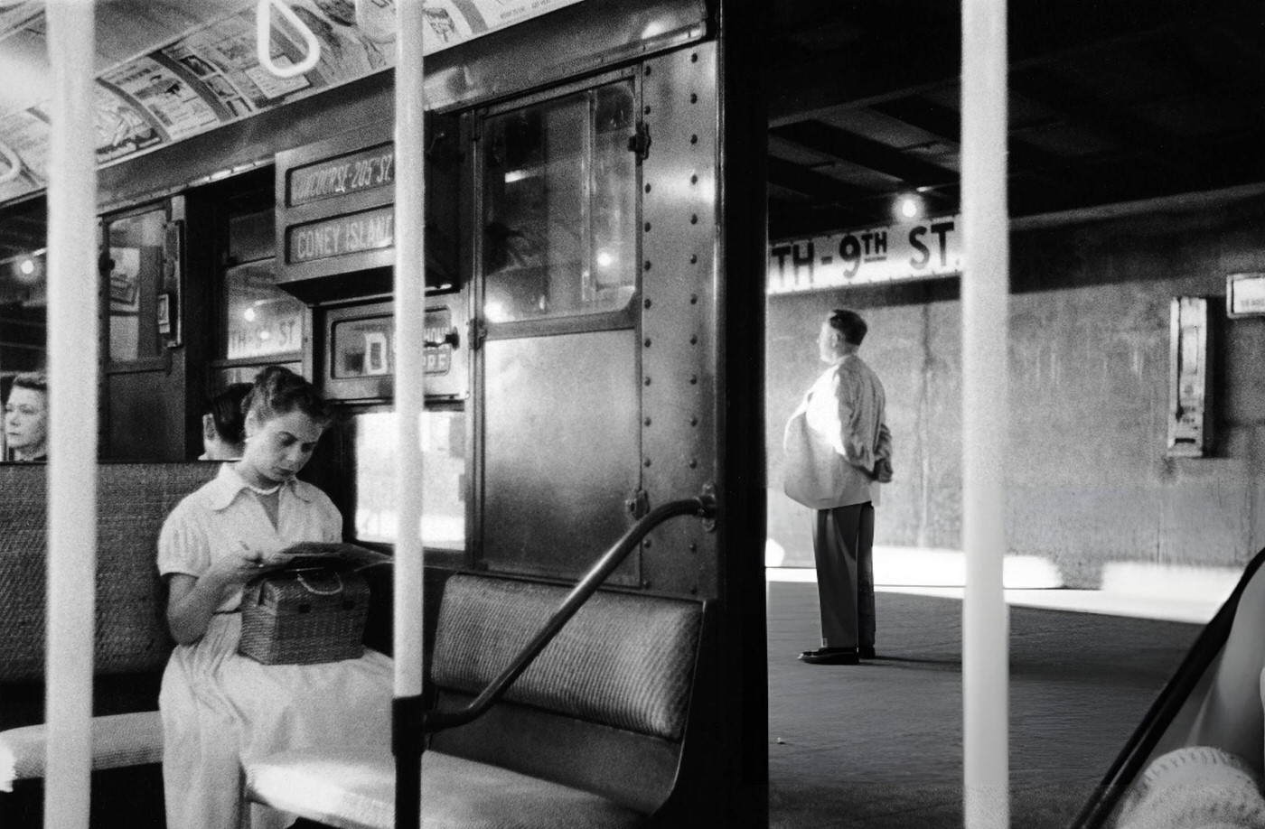 A Woman Seated On A Subway Car Reading A Newspaper, New York, 1969.