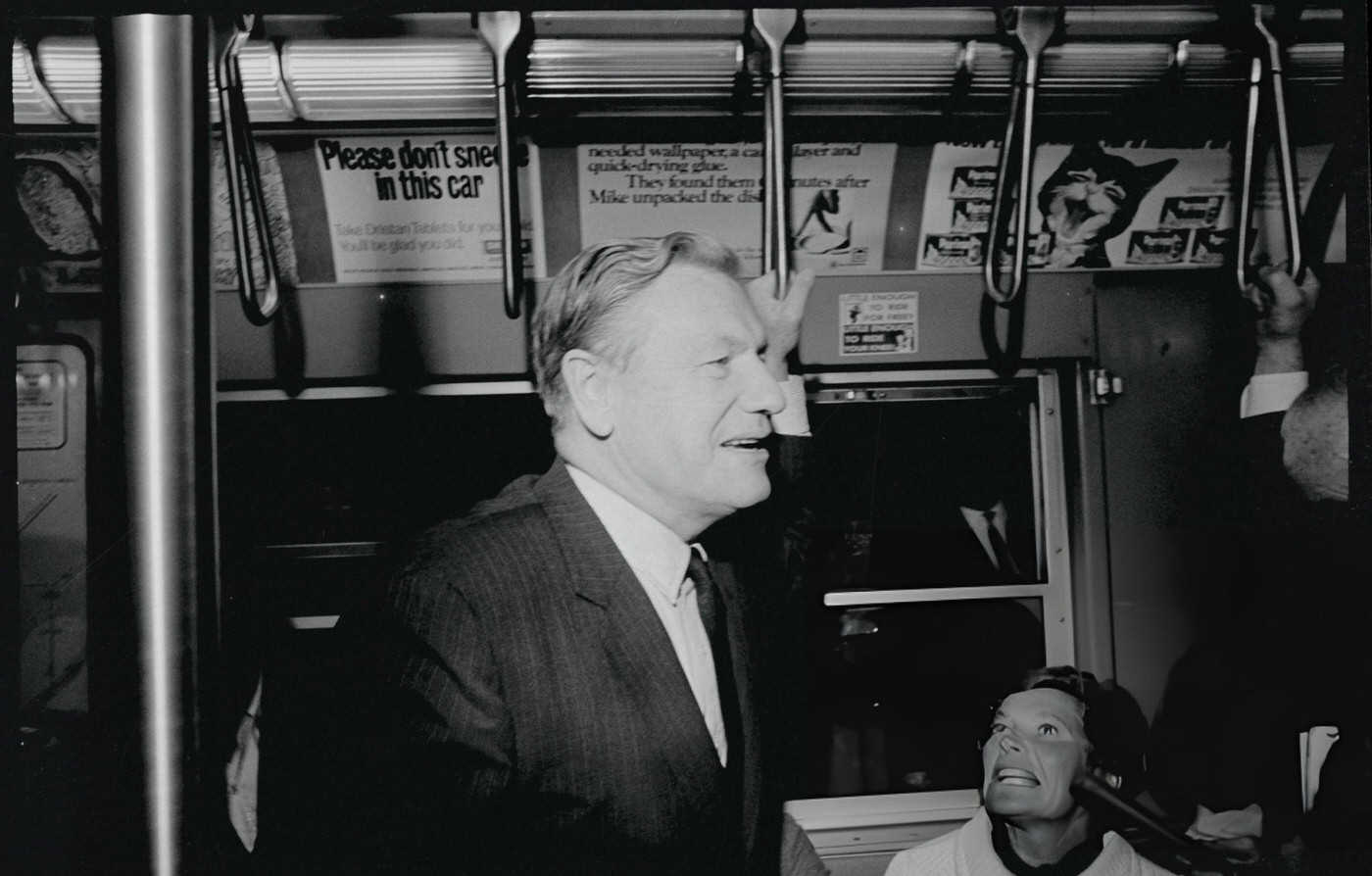 Governor Nelson Rockefeller Talks To Riders About The Transportation Bond Issue While Holding A Subway Train Strap, November 7, (Year Unspecified).