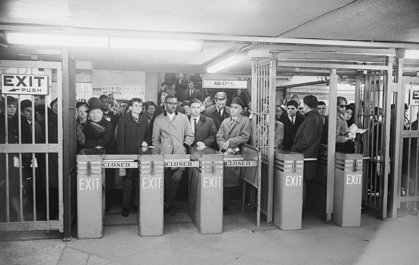 People Gather At The Turnstiles Of The Lexington Ave. Subway At 42Nd Street Early November 10Th, Waiting For Trains To Run Again After A Power Restoration, (Year Unspecified).