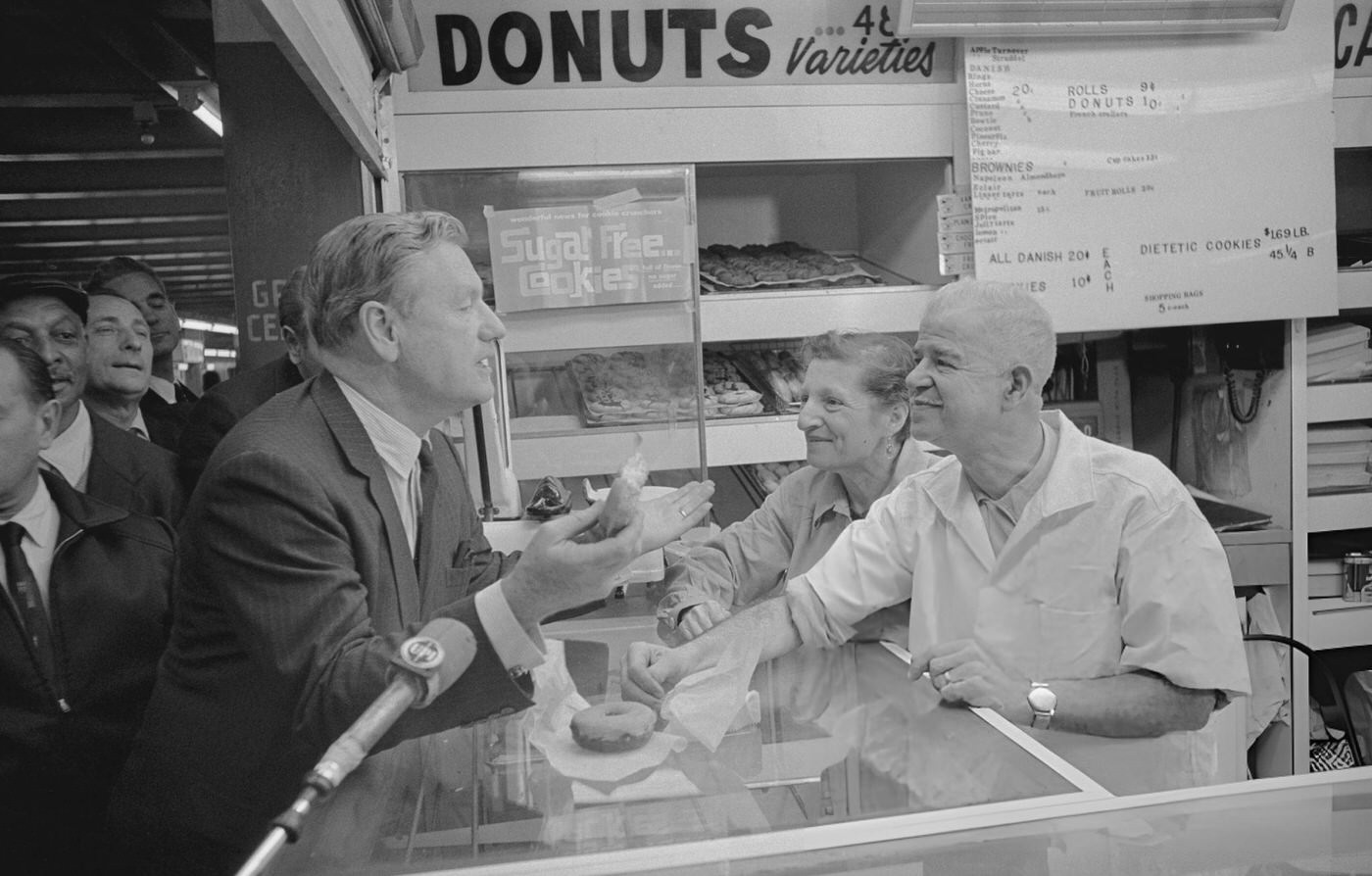 Governor Nelson Rockefeller Talks With Donut Shop Proprietors About The $2.5 Billion Mass Transportation Bond Issue During His Subway Riding Campaign, (Year Unspecified).