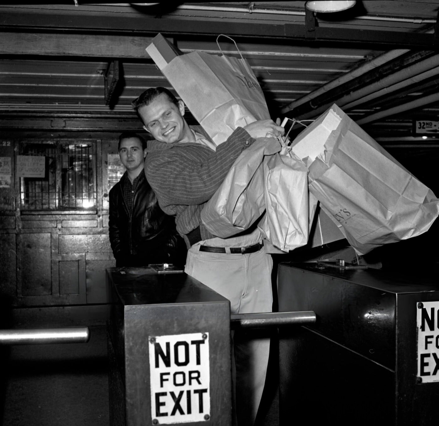 A Christmas Shopper Tries To Go Through A Subway Turnstile With Large Packages After Holiday Shopping In Manhattan, New York, December 17, 1961.