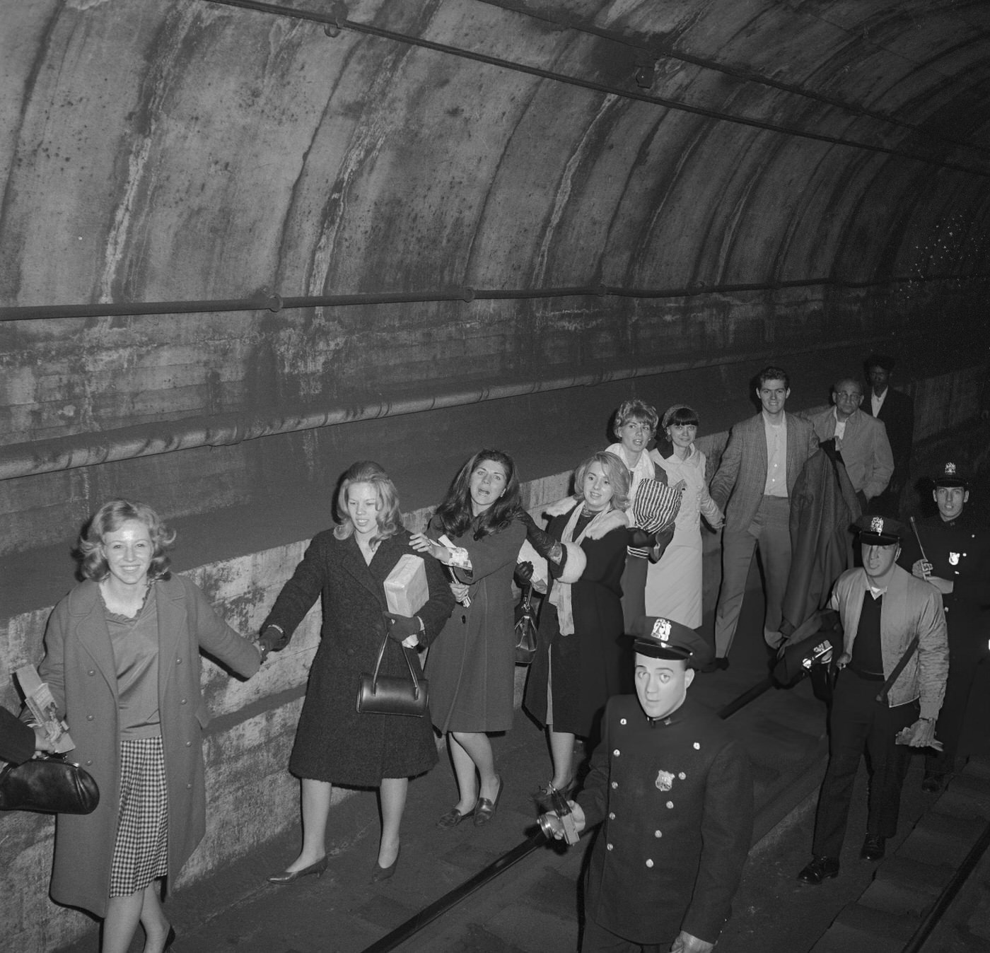 Policemen Lead Commuters Through A Subway Tunnel Following A Power Failure That Stopped All Trains, November 9, (Year Unspecified).
