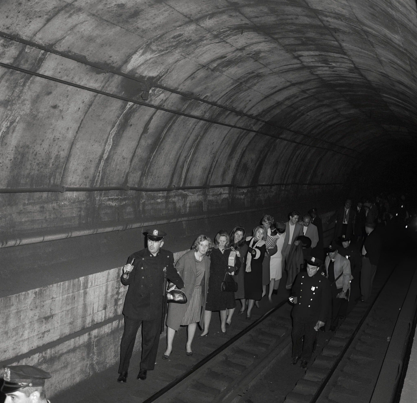 Policemen Lead Commuters Through A Subway Tunnel Following A Power Failure That Stopped All Trains, November 9, (Year Unspecified).