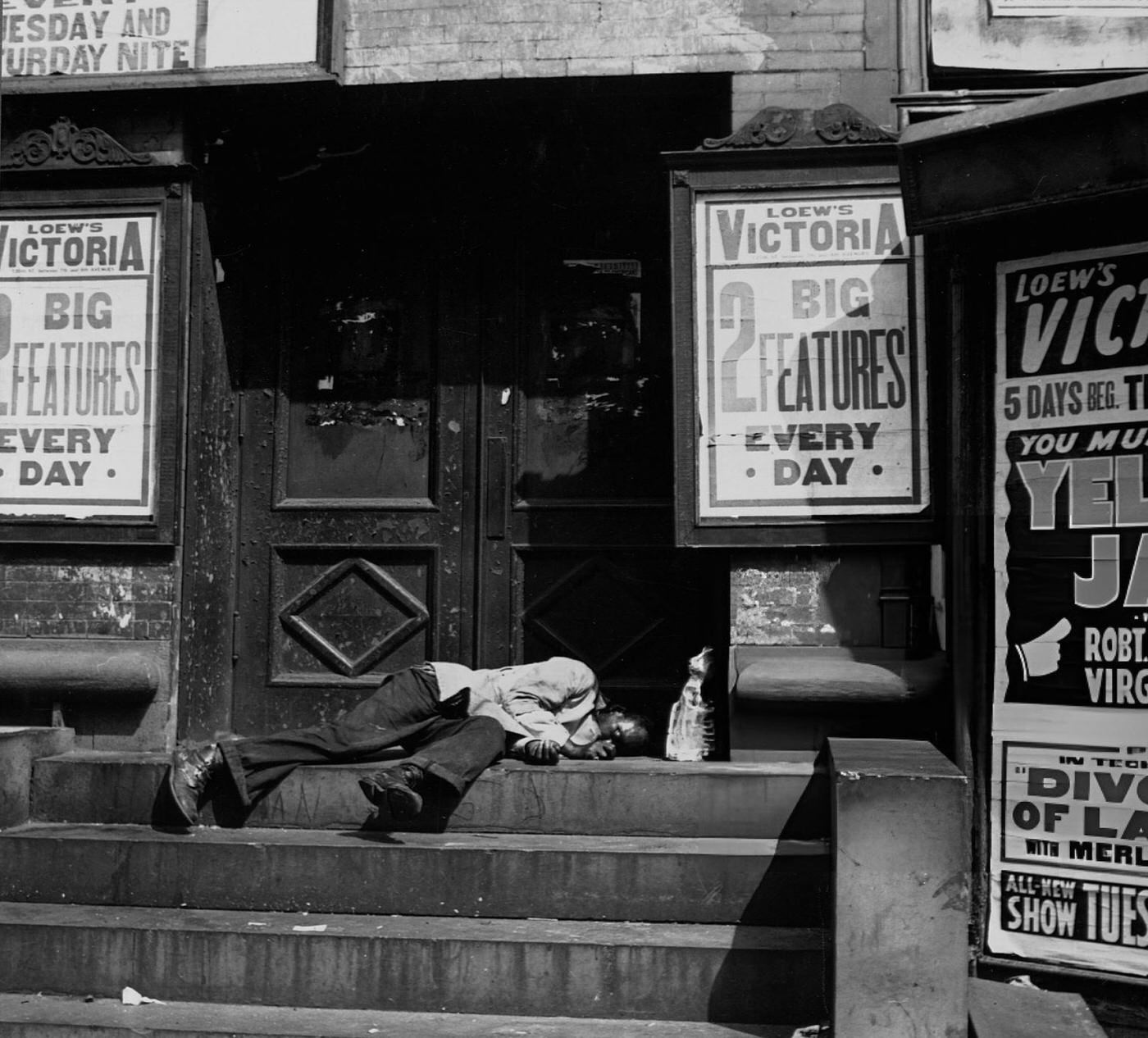 A Black Man Sleeps In The Doorway Of A New York Movie Theater During The Great Depression.