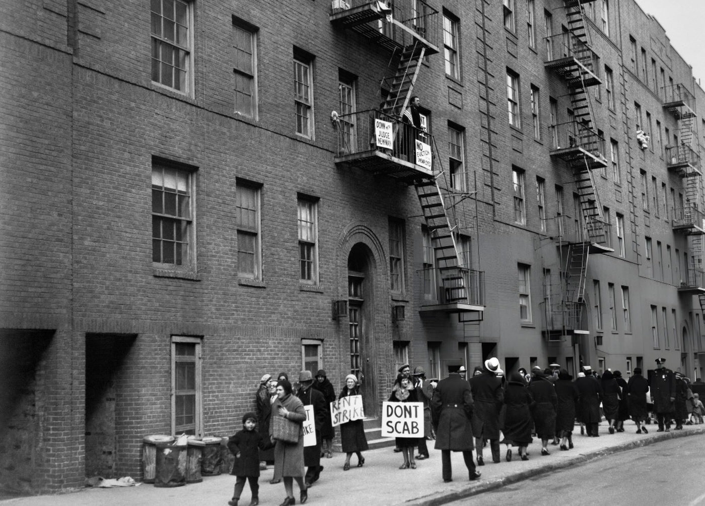 A Speaker Addresses Rent Strikers Gathered On The Street Below From A Fire Escape, Urging Mass Picketing In Front Of Apartments Facing Eviction, Bronx, March 14, 1932.