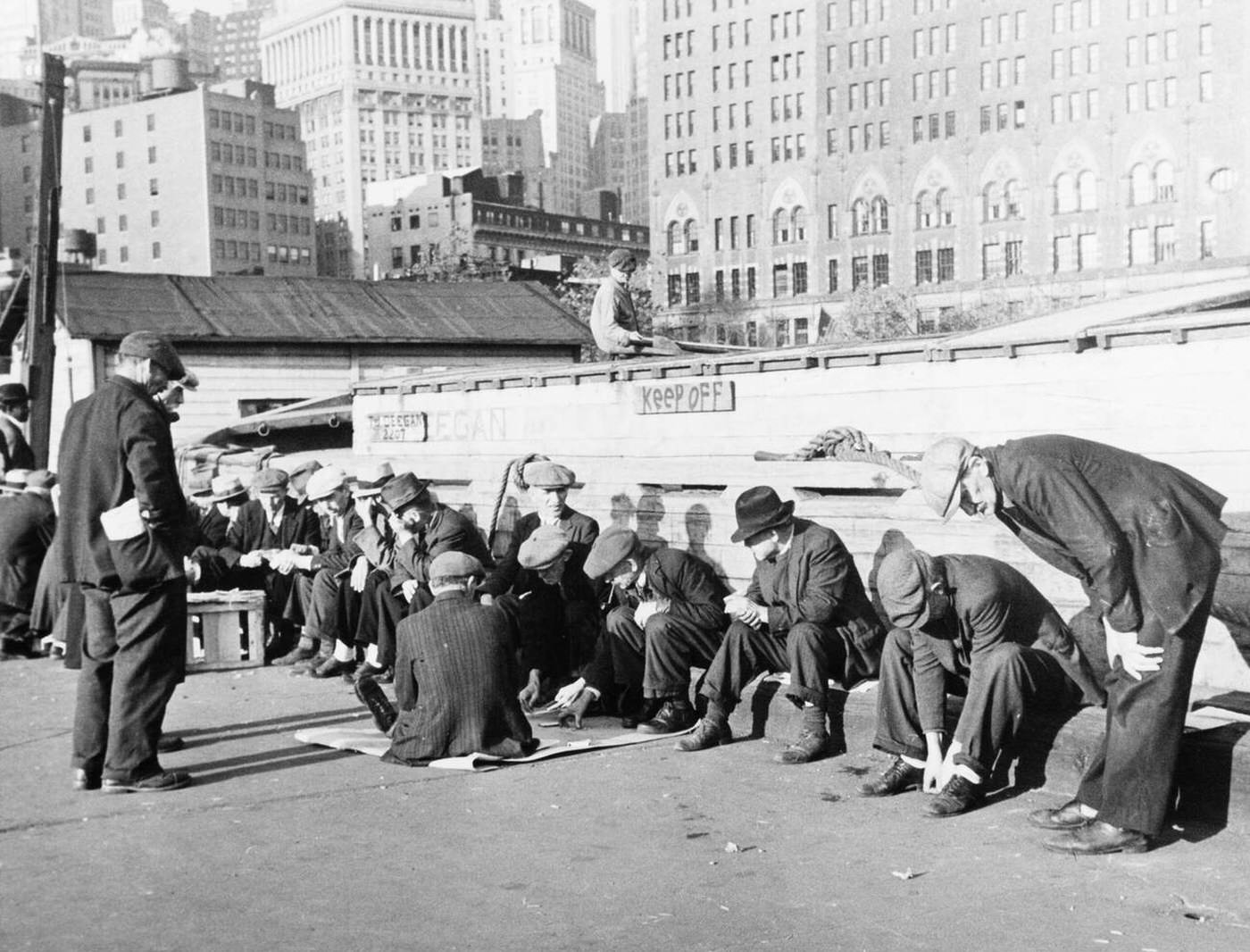 Unemployed Men Sitting In Sunshine On Coenties Slip Dock, Lower Manhattan, New York City, 1930S.
