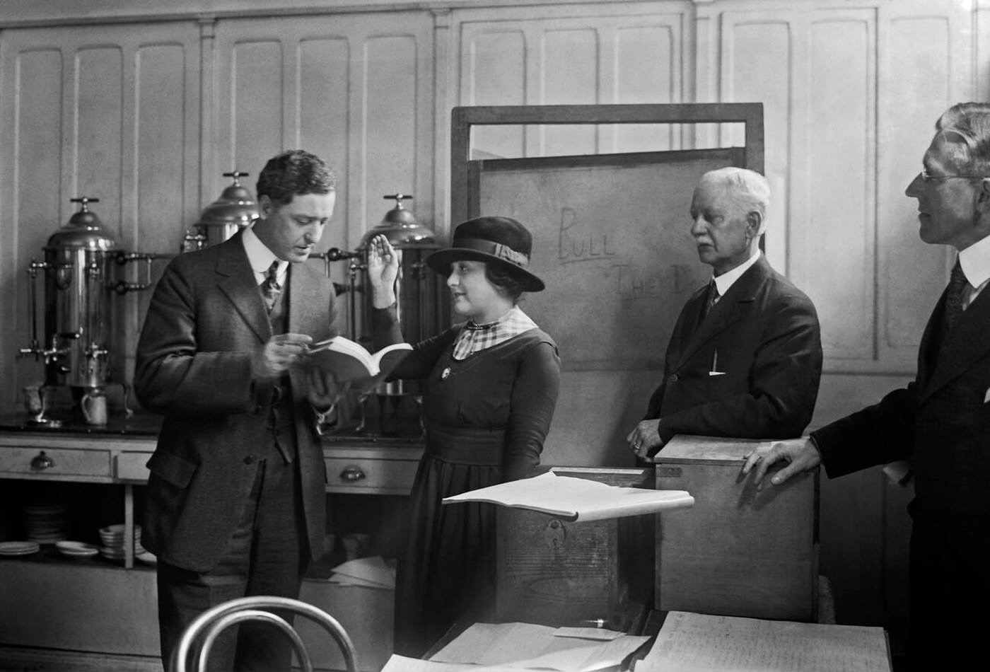 G.s. Mitchell Challenges Helen Moser As She Is Being Sworn In To Vote On March 5, 1918, The First Election In Which Women Could Vote In New York City, 1918.