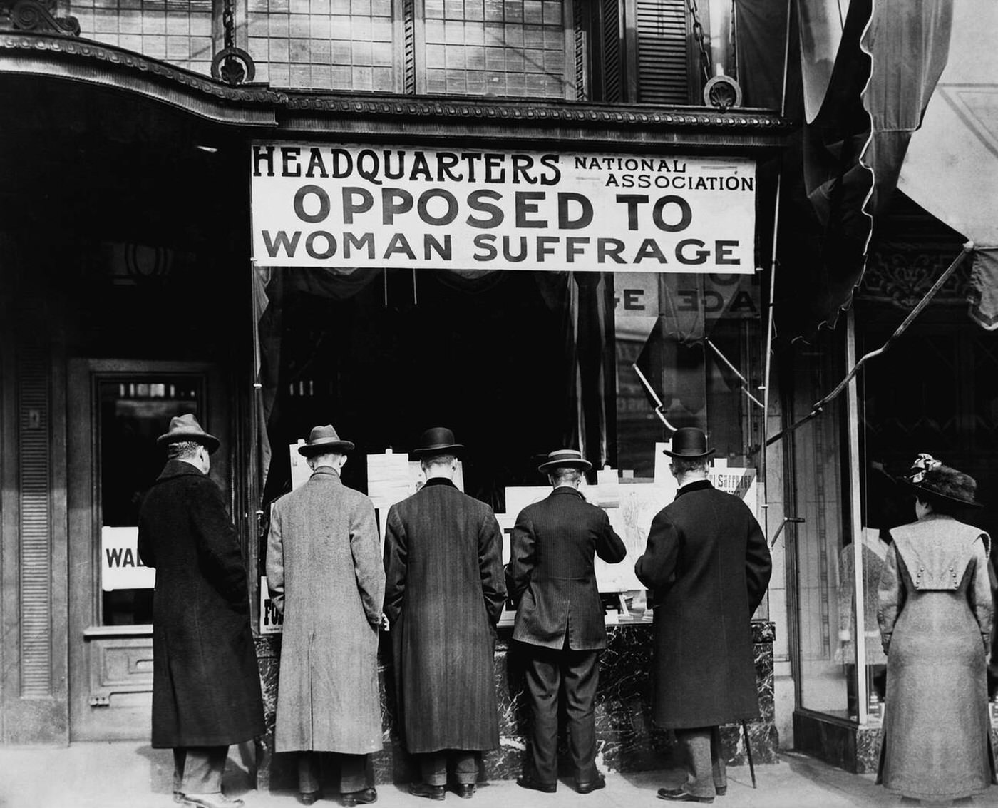 Men Looking At Material Posted In Window Of The National Association Opposed To Woman Suffrage Headquarters, 1911.