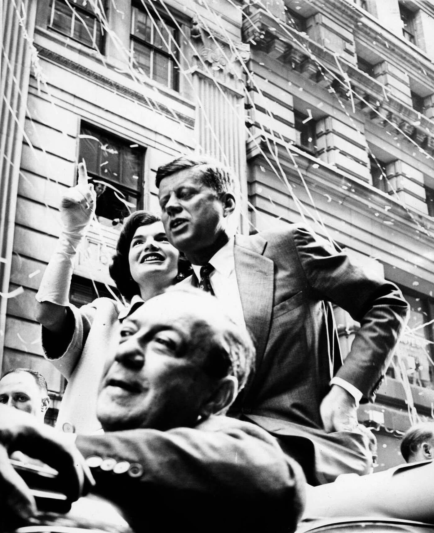 President John F. Kennedy Smiles With First Lady Jackie Kennedy At A Broadway Ticker Tape Parade, 1961.