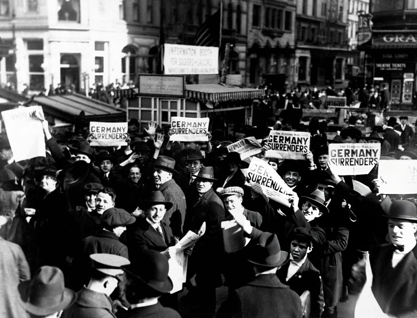 People In A Crowd At Times Square Hold Up Newspaper Extras Reporting Rumors Of Peace, 1918.