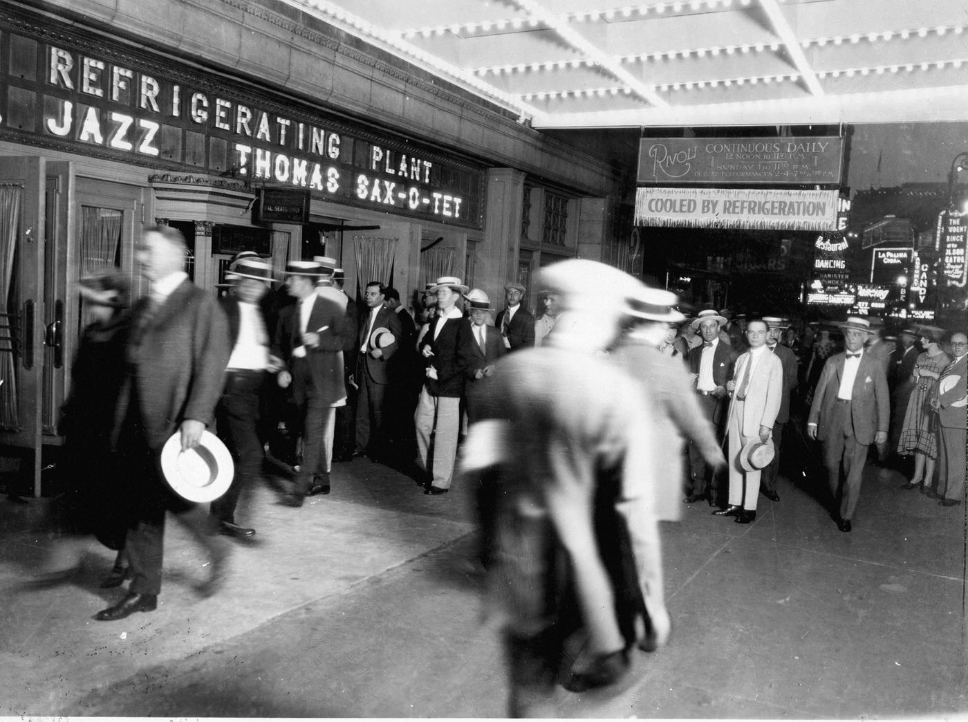 Nighttime View Of Traffic And Neon-Illuminated Theater And Cinema Signs In Times Square, 1920S Or 1930S.