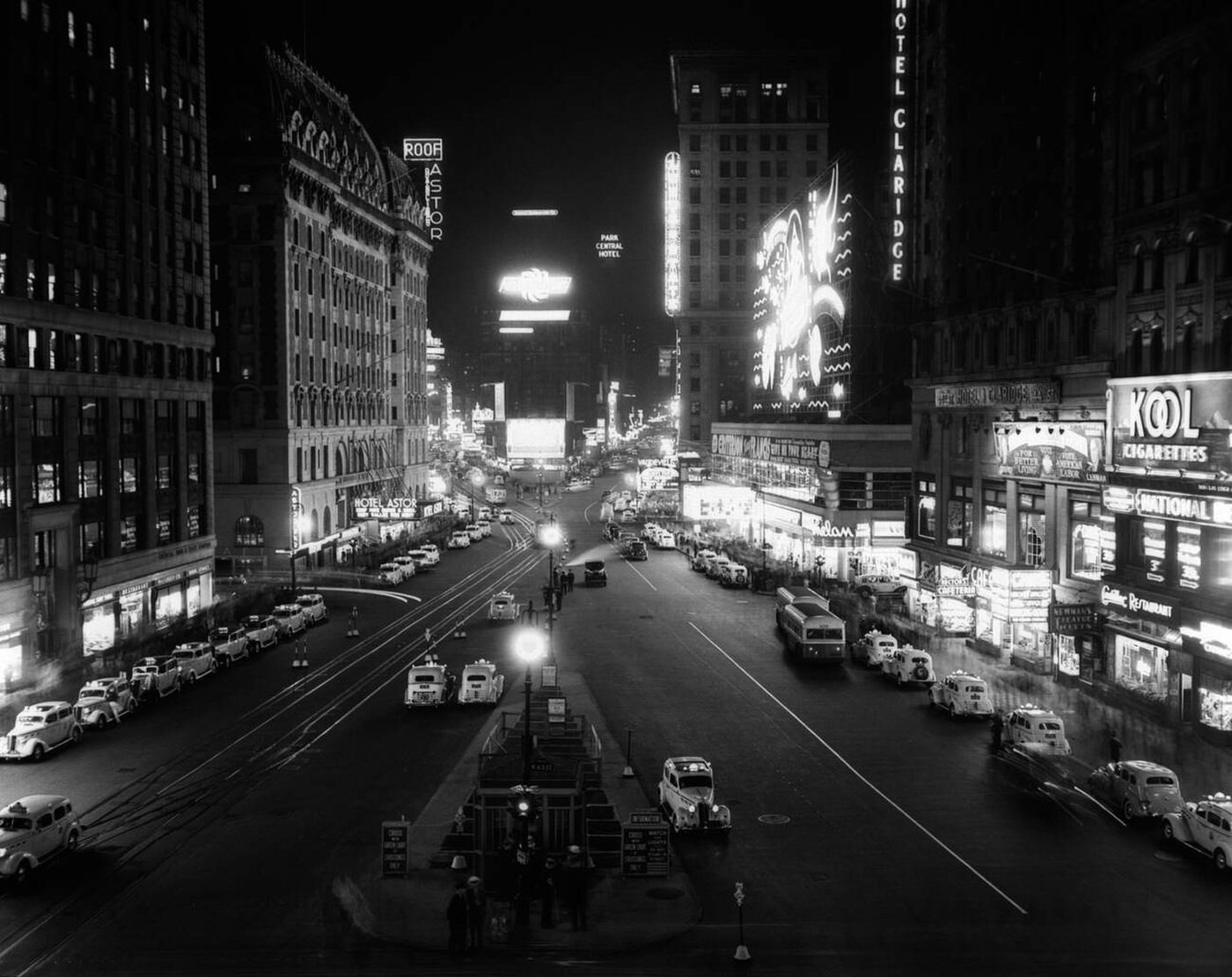 Overhead View Of Times Square Lit Up At Night With Cars Lining Curbs, 1930.