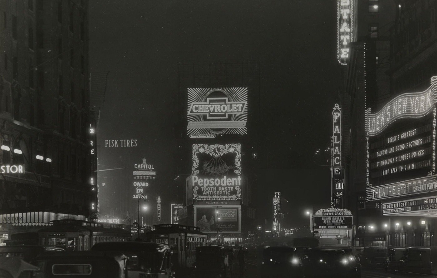 Times Square At Night. Traffic, Lighted Signs And Marquees Visible, 1930.