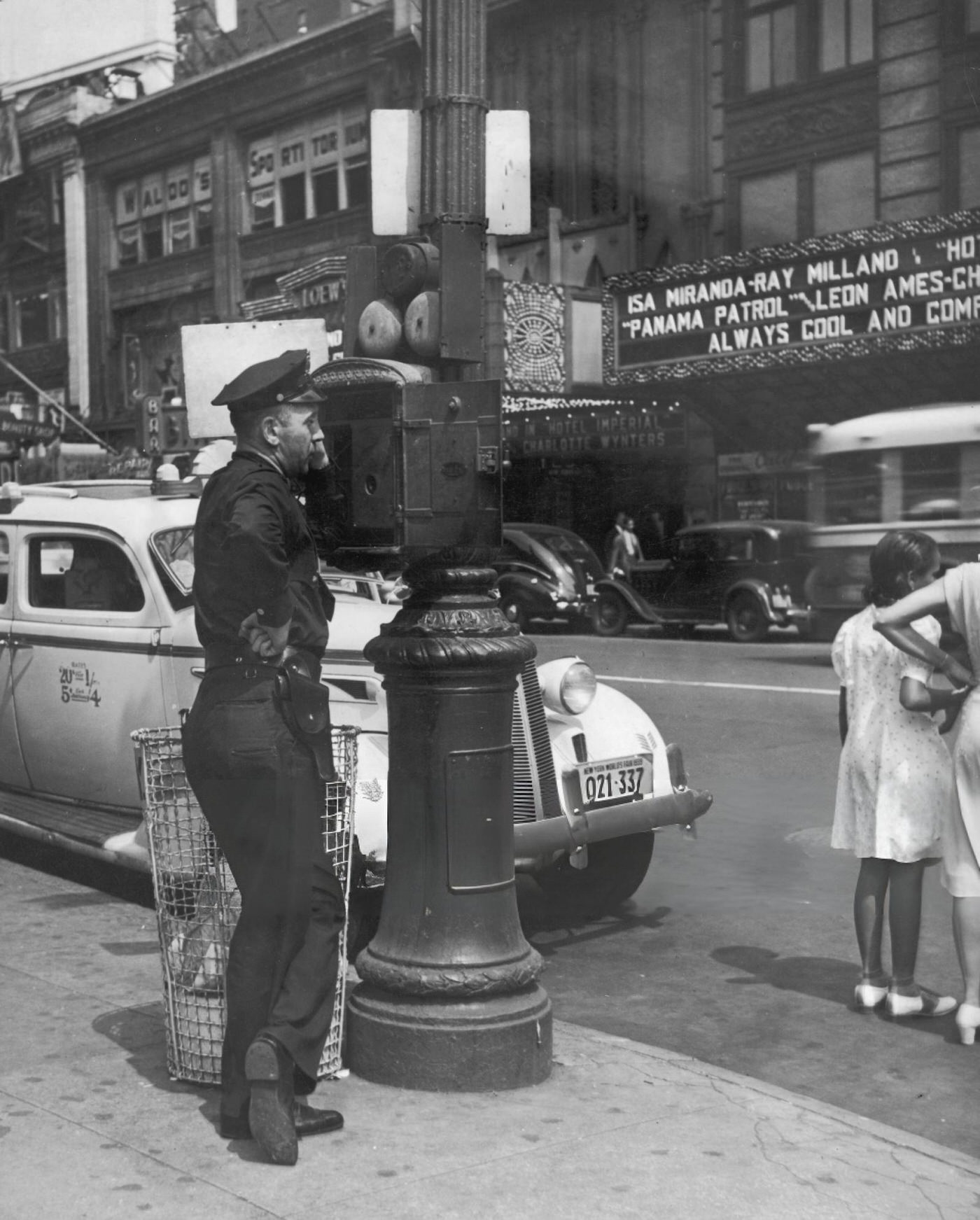A Police Officer Uses An Emergency Telephone In Times Square, 1939.