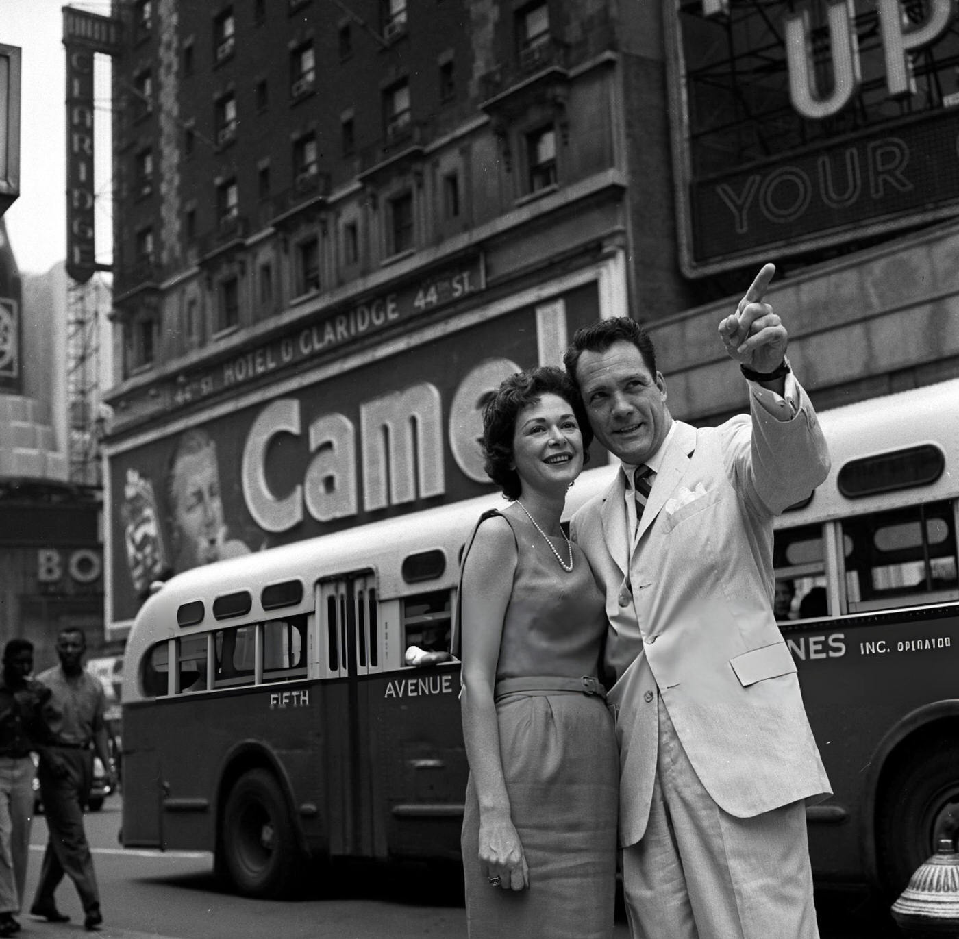 Carl Betz And His Wife Lois In Front Of A Camel Cigarettes Billboard In Times Square, October 15, 1959.
