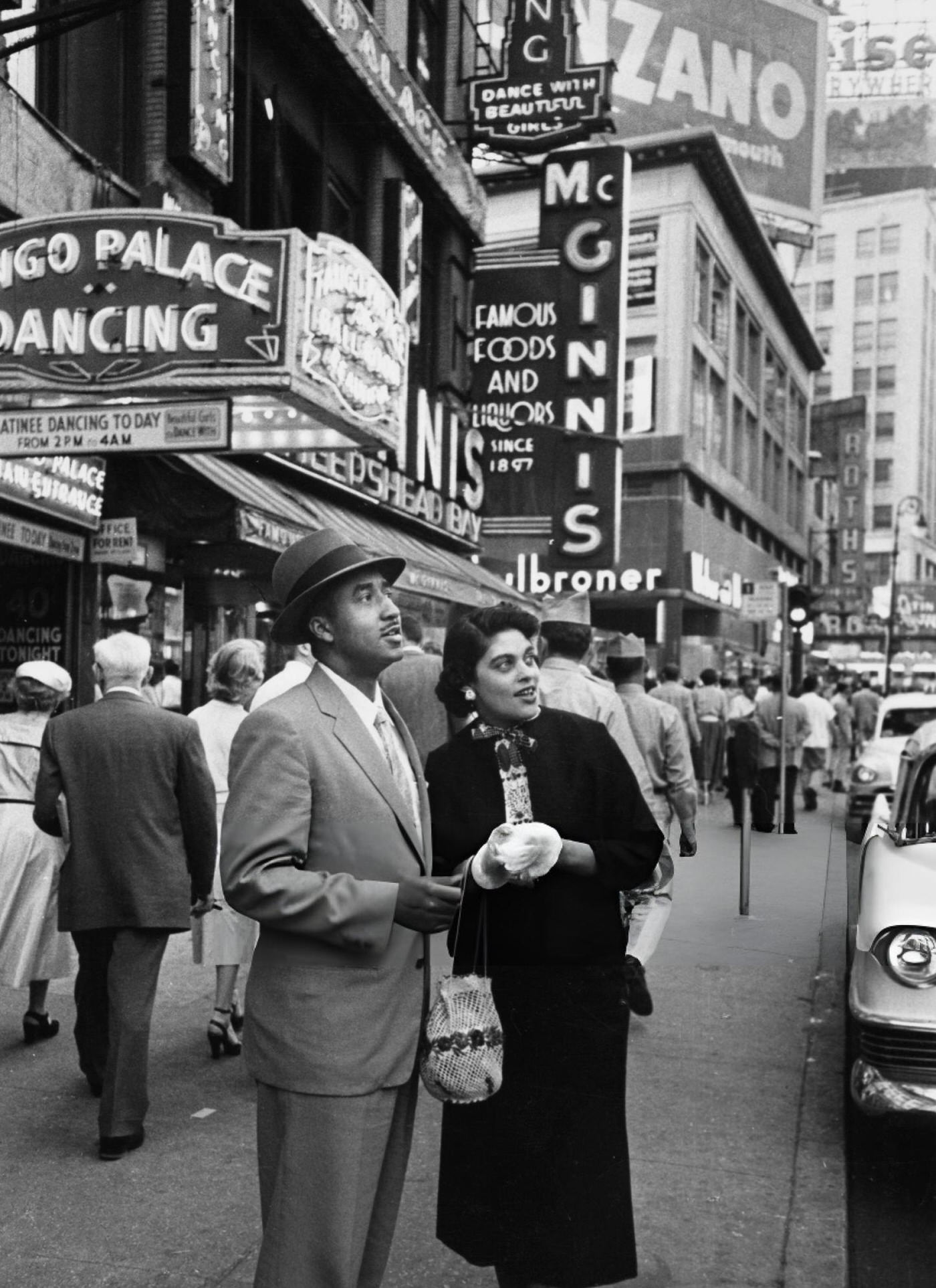 A Couple Admires The View Around Times Square On A Bustling Broadway, Circa 1950.