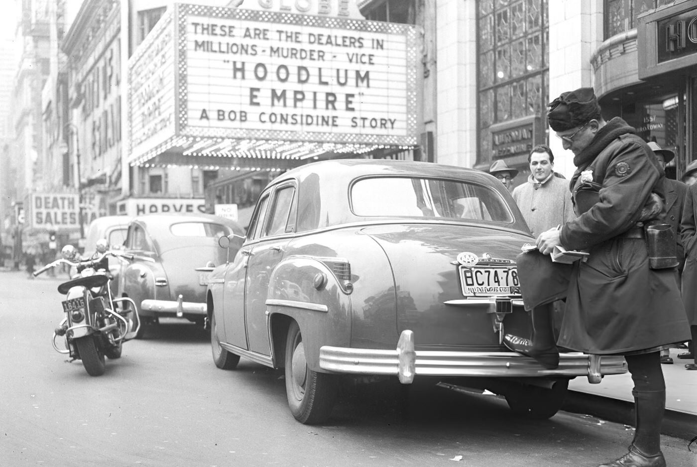 Motorcycle Cop Issues A Summons Despite A Period Of Grace For Violators Of The New Times Square Parking Ban, 1950S.