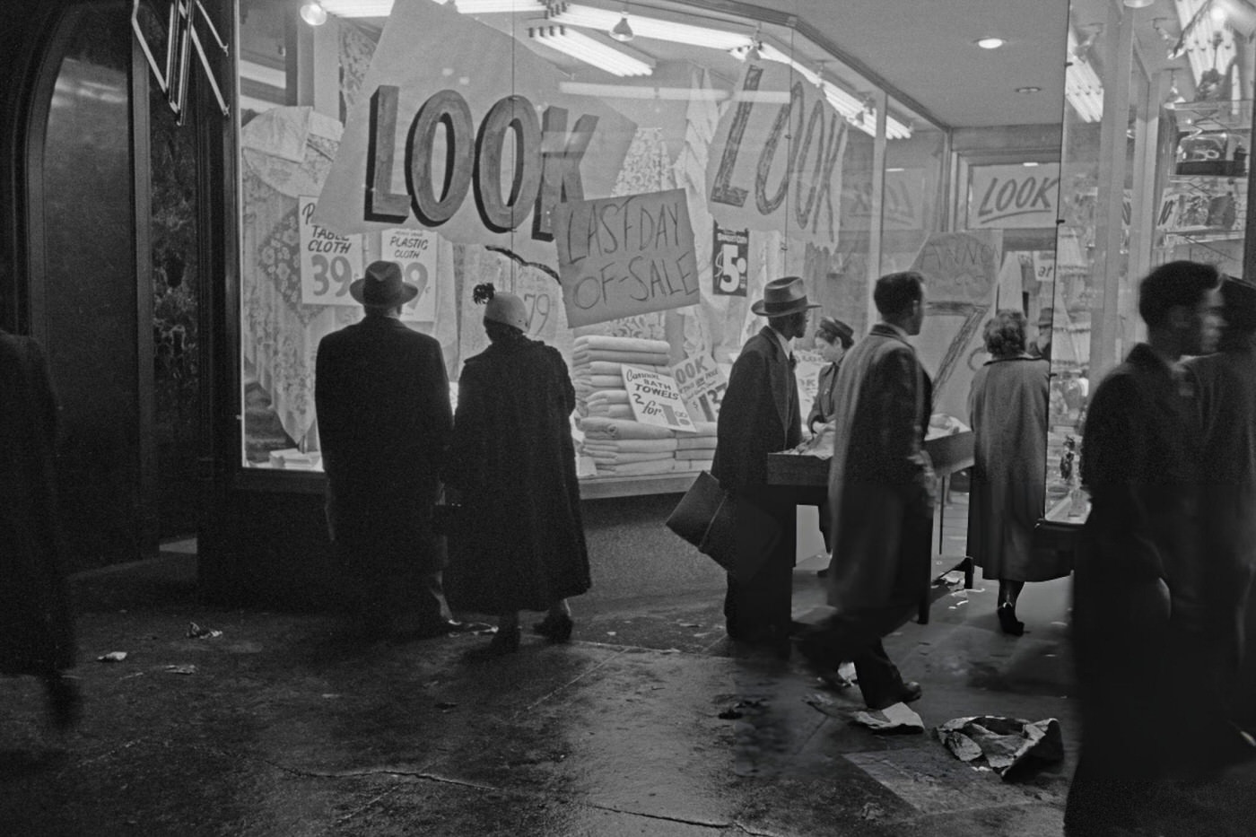 Signs Reading 'Look' And 'Last Day Of Sale' In A Shop Window In Times Square, January 1952.