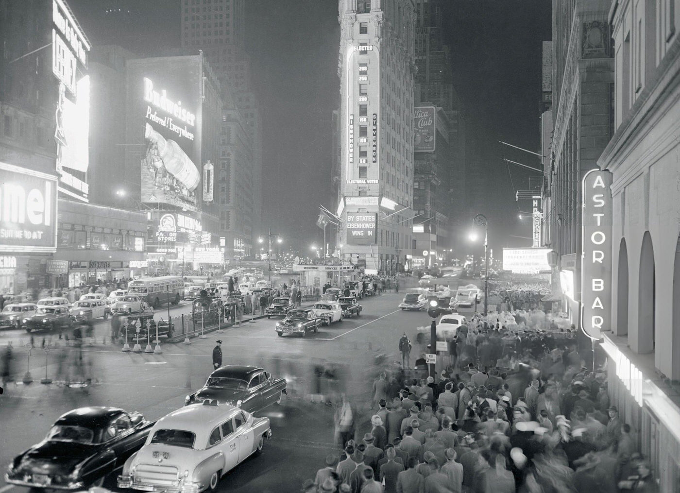 Pedestrians In Times Square Watch An Election Scoreboard On The New York Times Building, Showing Dwight D. Eisenhower'S Early Lead, 1952.
