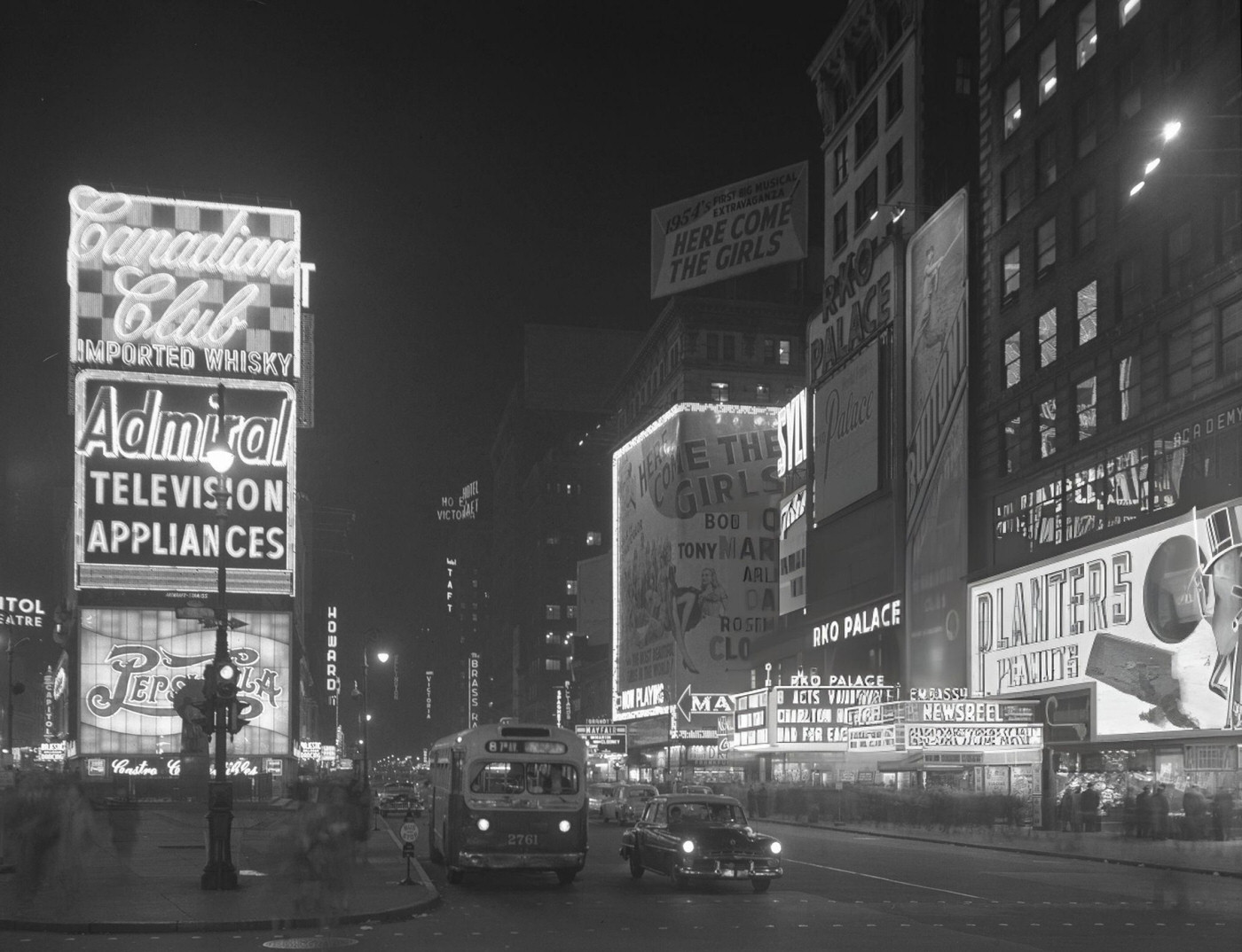 Nighttime View Looking North At Vehicular Traffic And Neon Advertising Signs In Times Square, December 29, 1953.