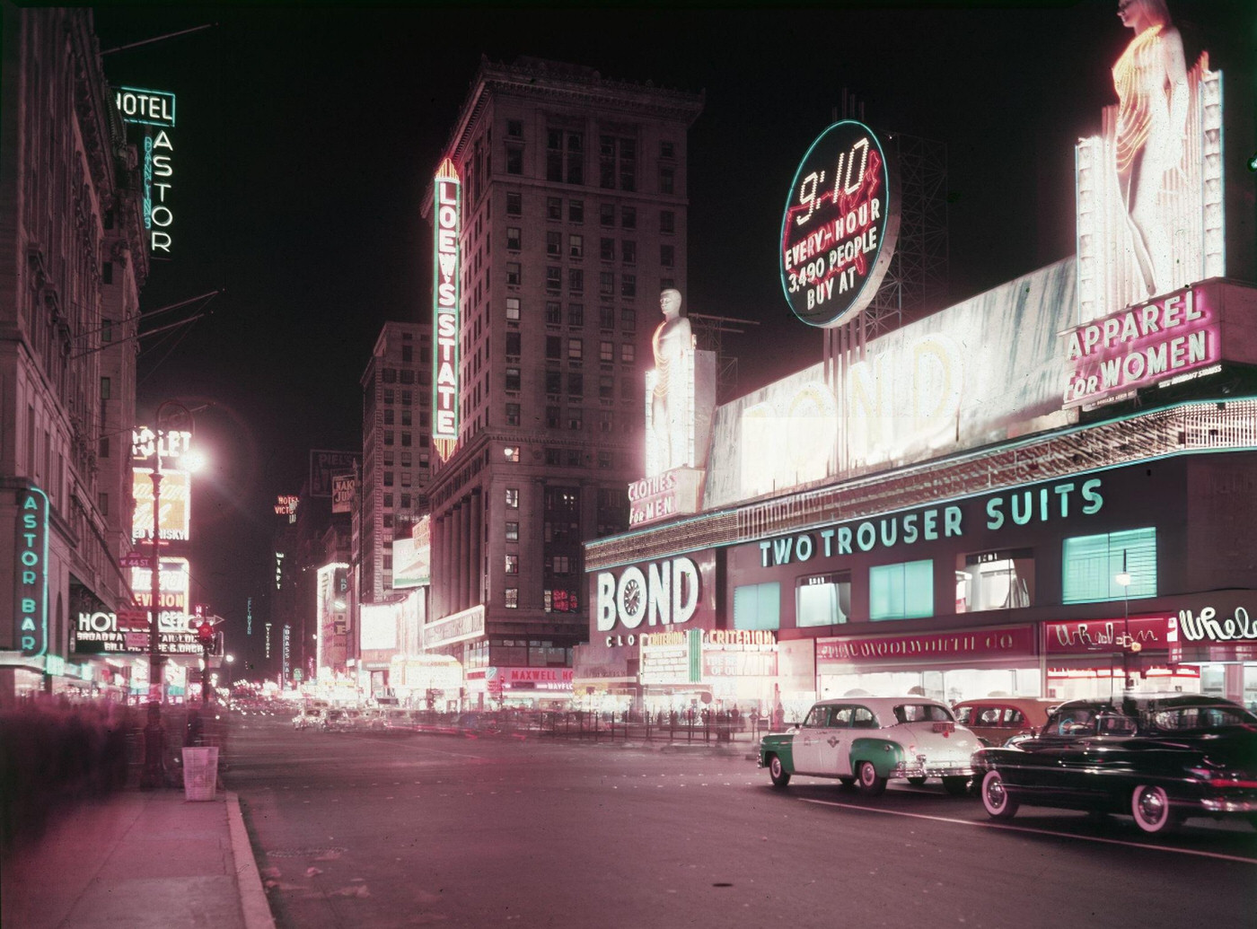 Neon Signs For The Hotel Astor, Loewe'S State Cinemas And The Bond Clothing Store At Night In Times Square, Circa 1955.