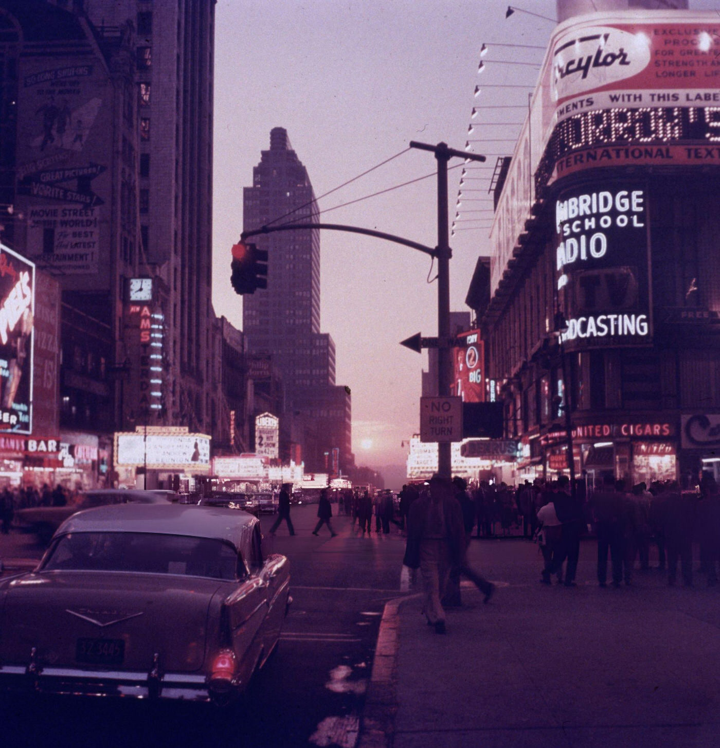 Street Scene Of Times Square, With Neon Movie Theater Marquees And People Crossing The Street, March 27, 1957.