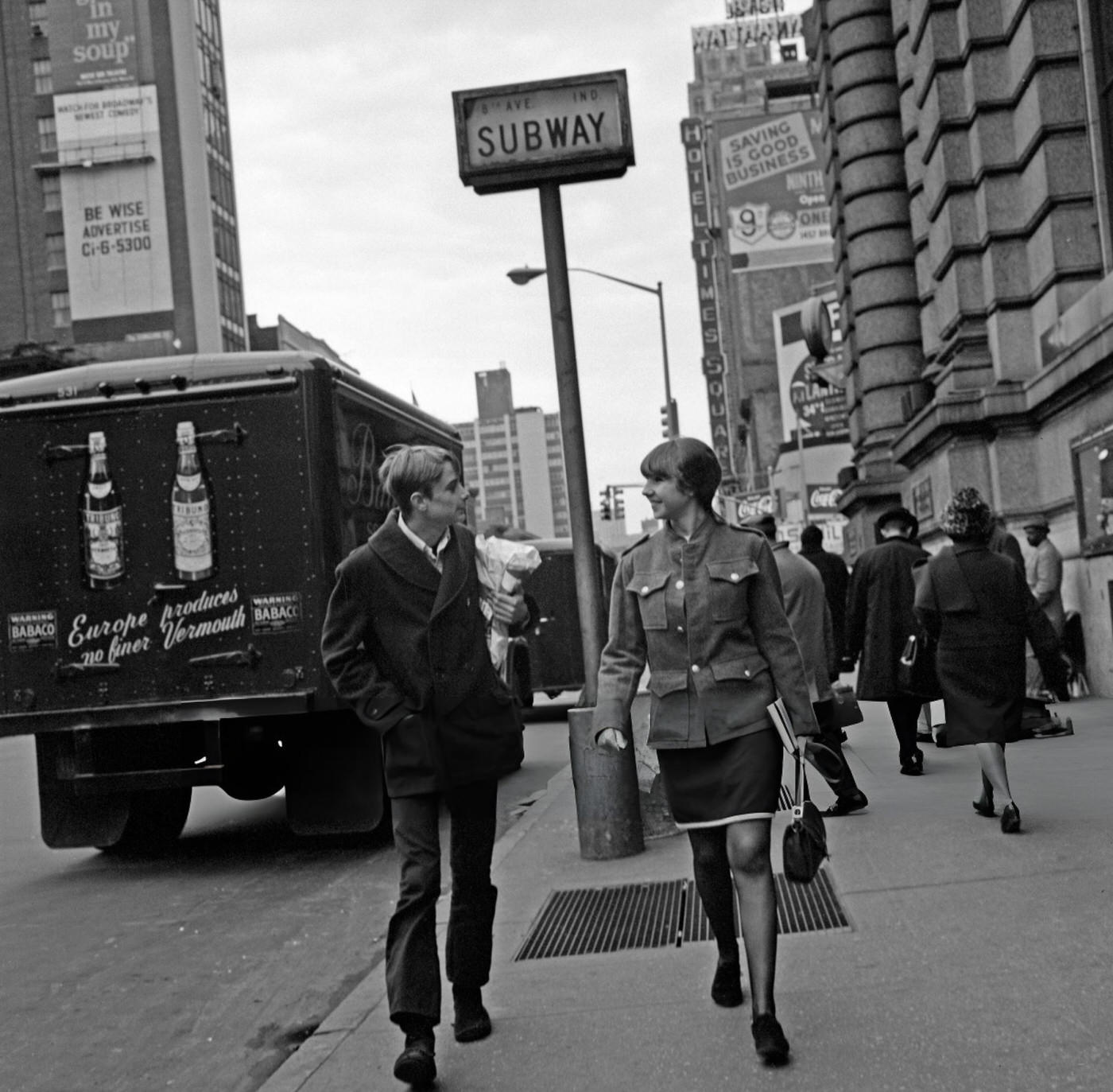 A Young Man Chats To A Young Girl As They Walk Down 42Nd Street And Eighth Avenue In Times Square, January 1, 1967.