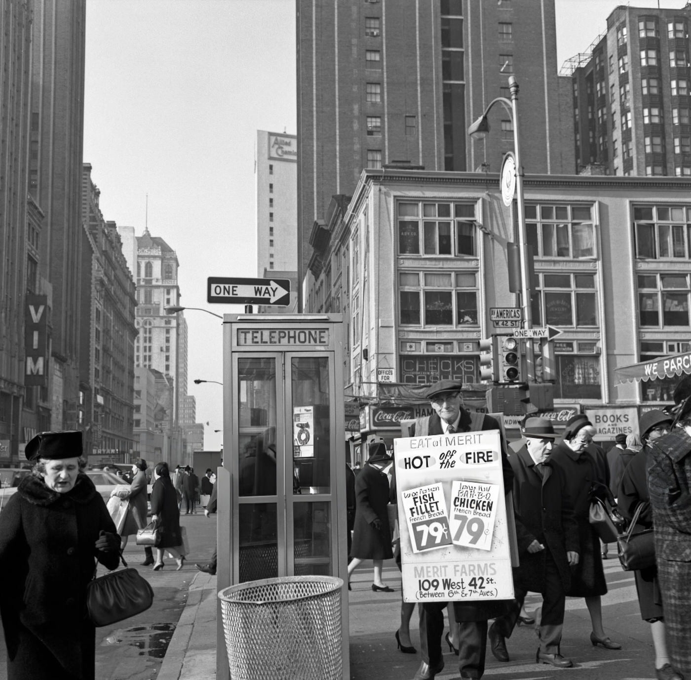 An Elderly Man Wearing A Billboard For A Local Restaurant Stands Next To A Pay Telephone Near Times Square, January 1, 1967.