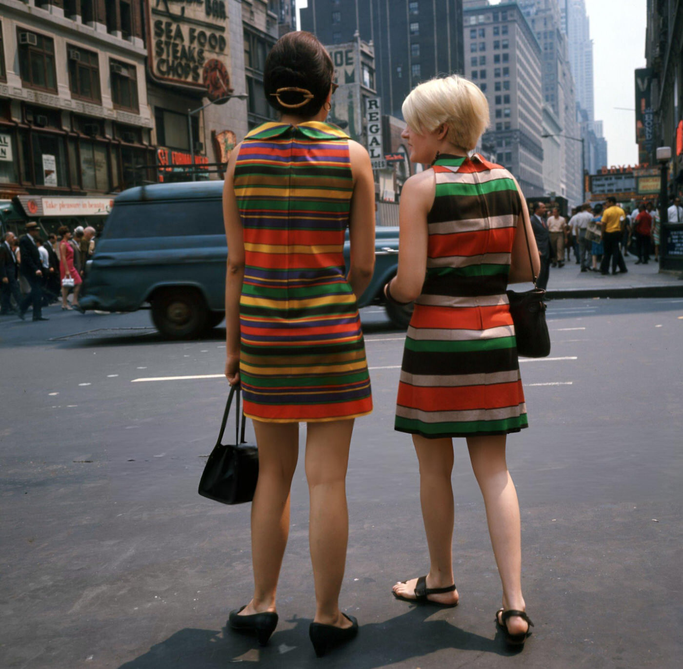Two Young Women, Wearing Colorful, Striped Dresses, Wait To Cross The Street In Times Square, June 1, 1967.