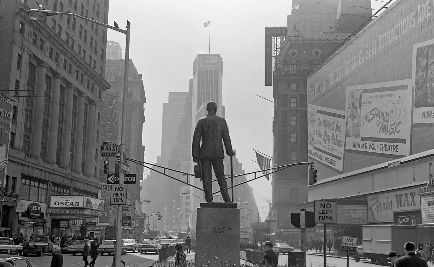 View, From Behind, Of The Statue Of George M Cohan In Duffy Square At The Intersection Of Broadway And West 46Th Street, March 1966.