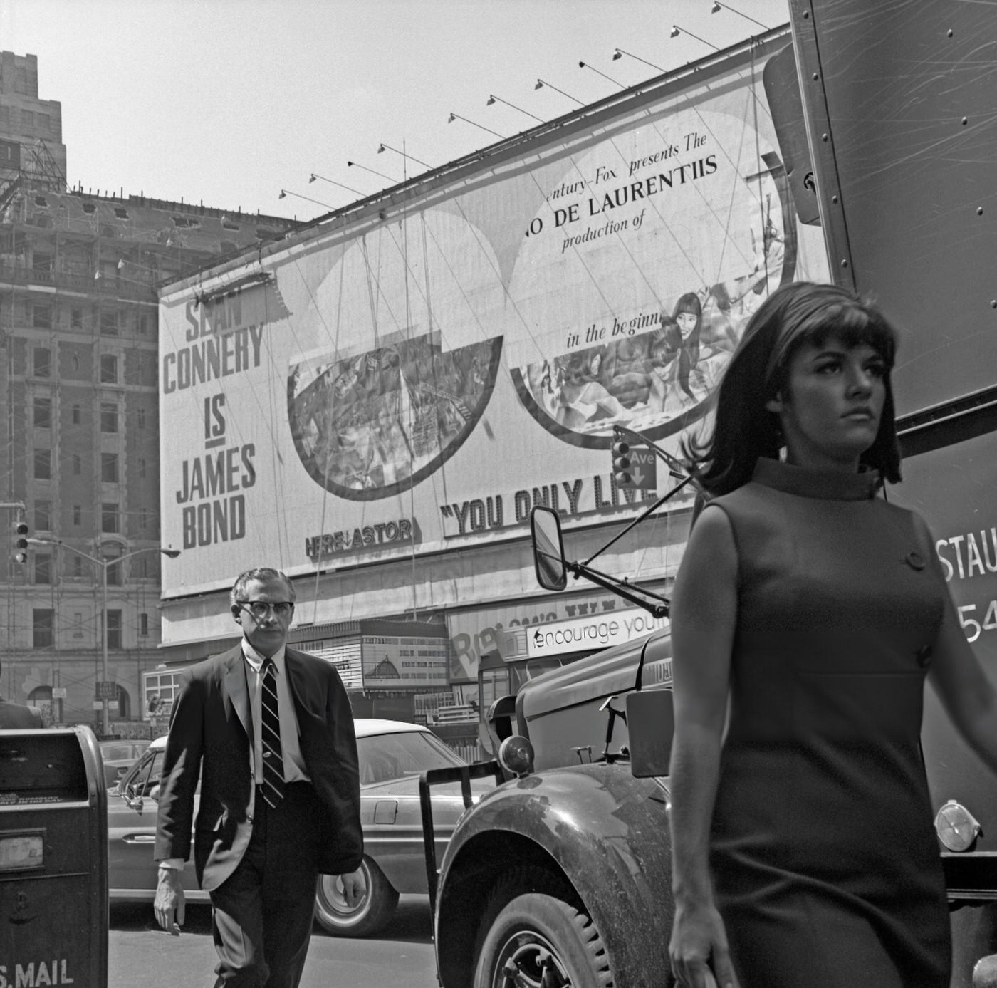 A Man Stares Intensely As He Follows A Young Woman Walking A Few Steps Ahead Of Him In Times Square, June 1, 1967.