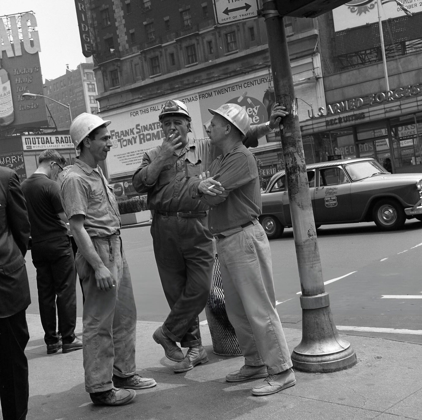 Three Construction Workers Take A Cigarette Break On Broadway In Times Square, July 1967.