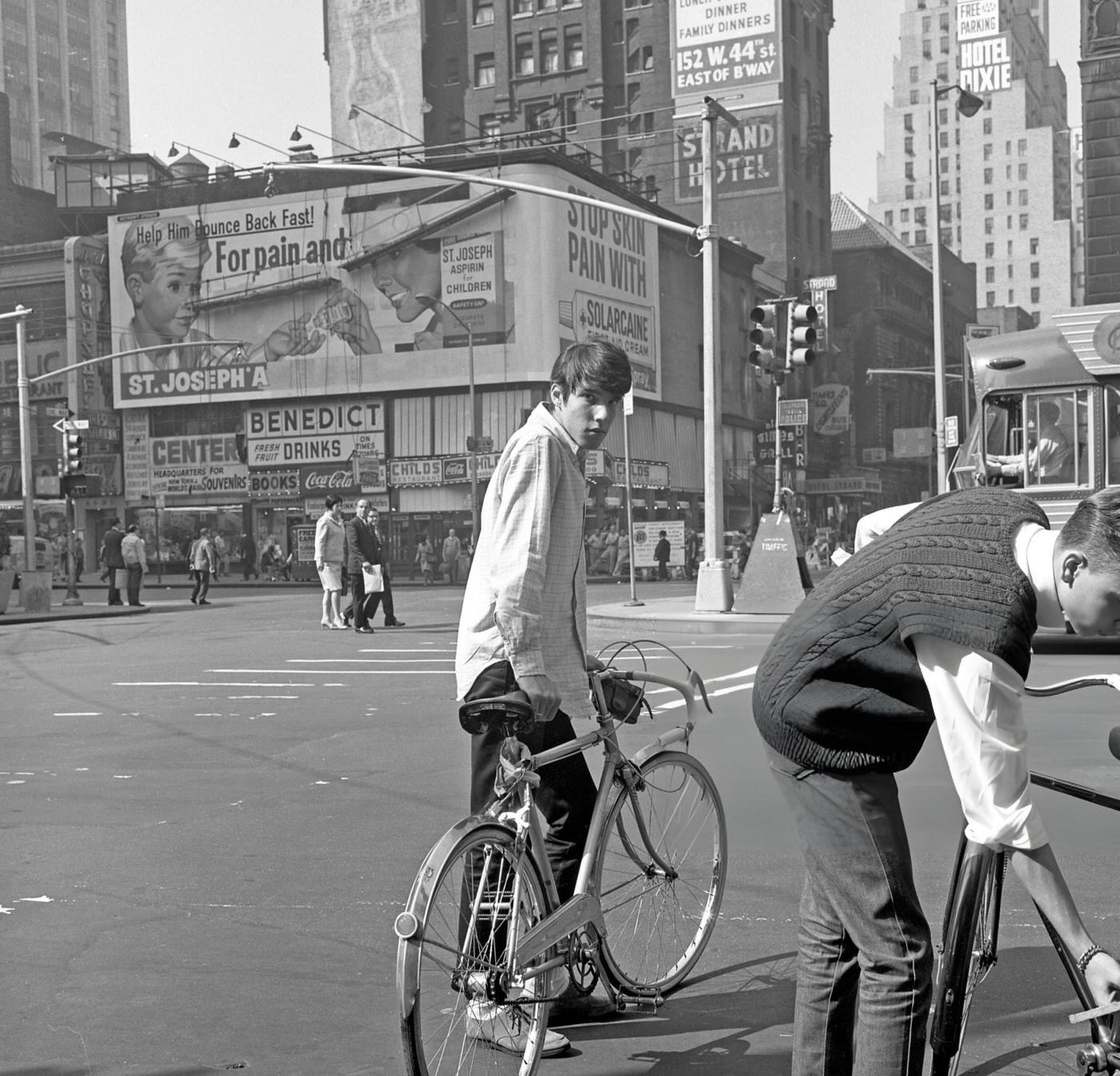 View Of A Young Man Looking At The Camera As He Stands Next To His Bicycle At The Southwest Corner Of 7Th Avenue (At West 42Nd Street) In Times Square, October 1967.
