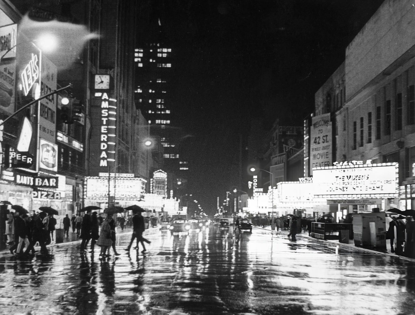 Nighttime View Of 42Nd Street In The Rain With Illuminated Theater Marquees And Neon Signs, Time Square.